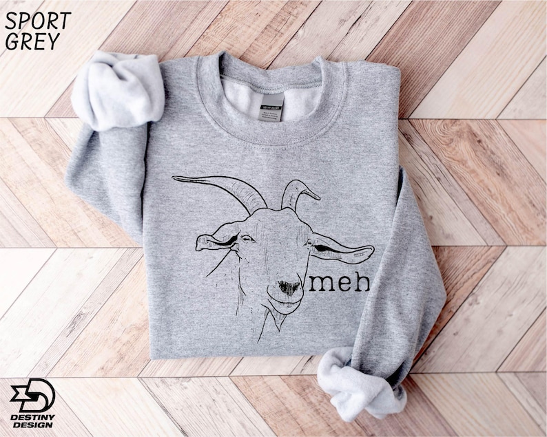 a grey sweatshirt with a goat on it