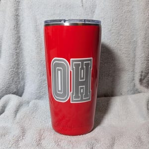 May include: A red stainless steel tumbler with a gray "OH" graphic.