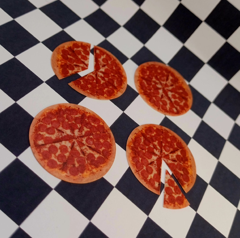 May include: Four mini pepperoni pizzas on a black and white checkered surface. Each pizza is cut into slices and has a red and brown crust.