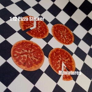 May include: Four 1:12 scale pizza stickers on a black and white checkered background. The stickers are round and feature a pepperoni pizza with a slice removed. The text "1:12 Pizza Sticker" and "Miniatures" are visible in the image.