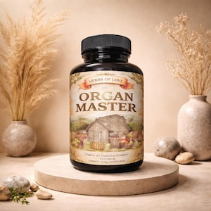 May include: A black bottle with a black cap, labeled "HERBS OF LOVE" and "ORGAN MASTER." The label features a rustic illustration of a wooden building and produce. The bottle sits on a round, beige platform, with dried plants in vases on either side.