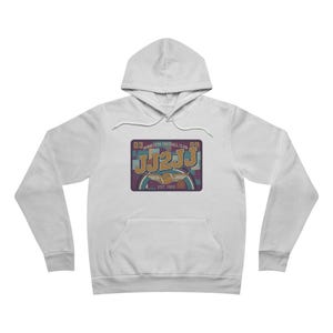 May include: White hooded sweatshirt with a front graphic. The graphic features the text "JJ2JJ" in a vintage style, with the words "Minnesota Football Club" and "EST. 1969". The design includes a football and a color block pattern.