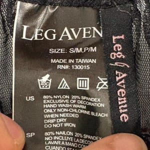 May include: A black clothing tag with the brand name "LEG AVEN" in white block letters. The tag includes washing instructions, size information, and the text "MADE IN TAIWAN". The tag also lists the materials used.