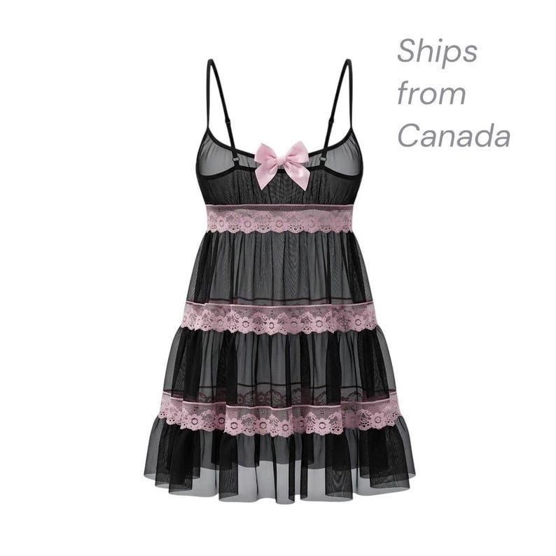 May include: Black babydoll lingerie with a sheer overlay and pink lace trim. The lingerie features a pink bow at the bust and spaghetti straps. The skirt has multiple tiers with lace detailing, creating a layered effect.