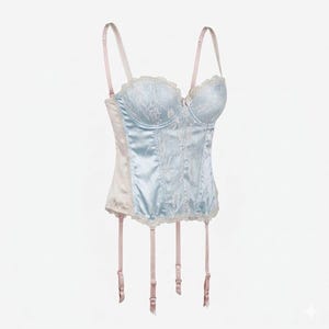 May include: A light blue satin corset with lace detailing. The corset has a sweetheart neckline, adjustable straps, and garter straps. The corset is trimmed with lace and has a pale pink trim.