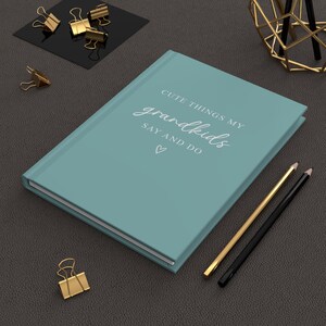May include: A teal blue hardcover journal with the text "Cute things my grandkids say and do" in white lettering. A heart symbol is below the text.