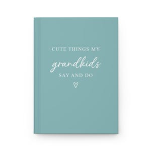 May include: A teal blue journal with the text "Cute things my grandkids say and do" in white lettering. A small white heart is below the text.