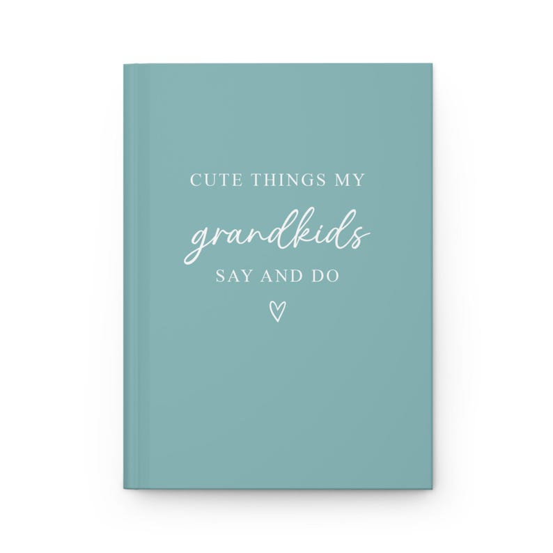 May include: A teal blue journal with the text "Cute things my grandkids say and do" in white lettering. A small white heart is below the text.