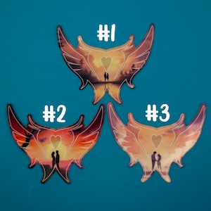 May include: Three colorful butterfly-shaped stickers with a couple silhouette and a heart in the center. The stickers are numbered #1, #2, and #3.