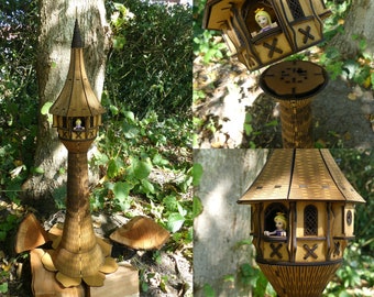 May include: A wooden tower with a brown roof and a small figure inside. The tower is made of laser-cut wood and has a detailed design. The tower is sitting on a wooden base.