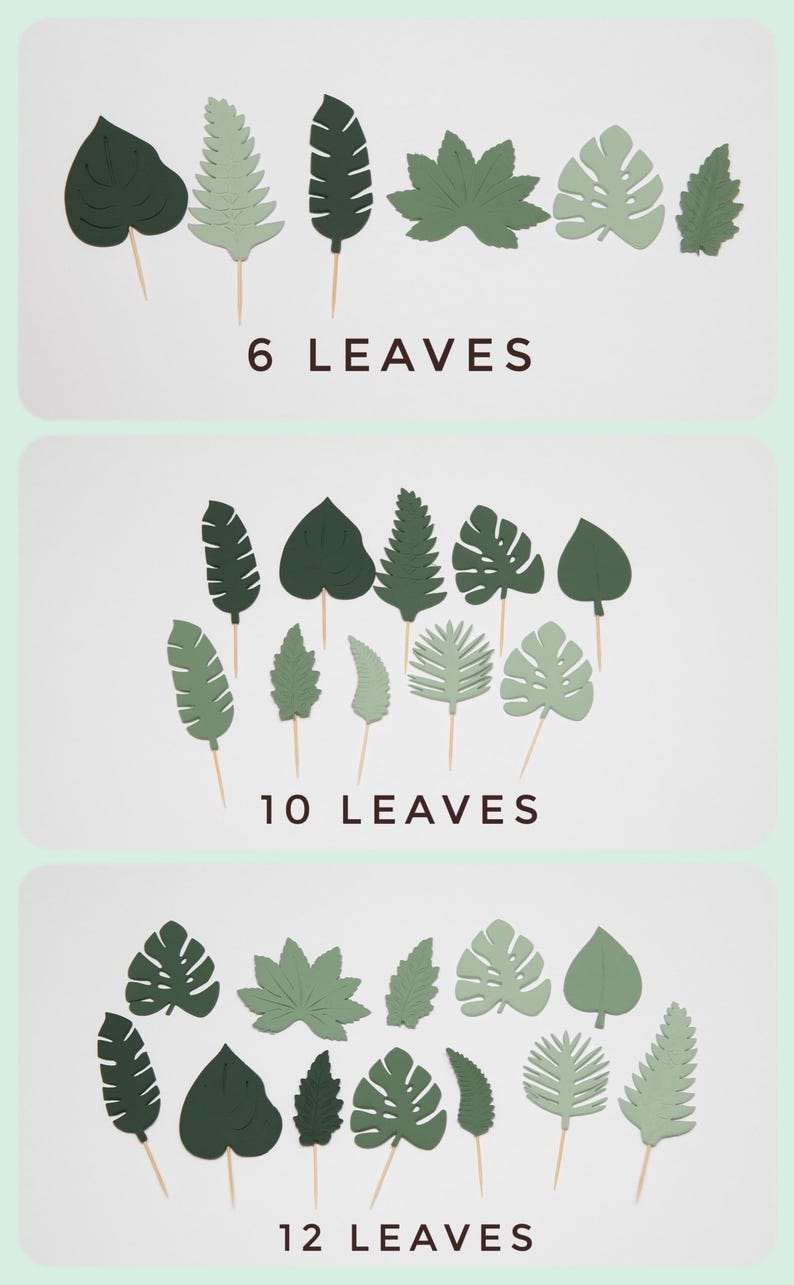 May include: Three sets of green paper leaves on wooden skewers. The sets include 6, 10, and 12 leaves. The leaves are various shapes, including monstera, fern, and heart.