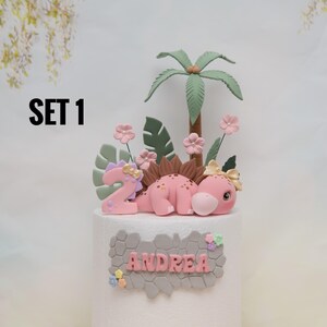 Baby Girl Dinosaur Cake Topper Made of Lightweight Air Dry Clay: Triceratops, T-rex, Brontosaurus, Stegosaurus, For Birthday Cake Set 1 w/ Pink Stego