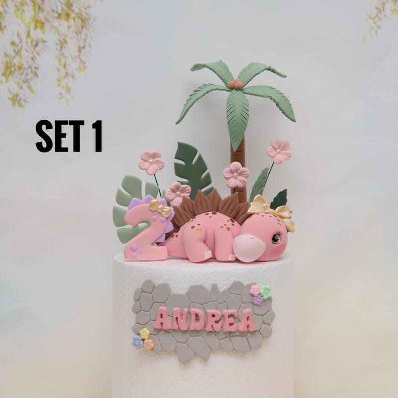 Baby Girl Dinosaur Cake Topper Made of Lightweight Air Dry Clay: Triceratops, T-rex, Brontosaurus, Stegosaurus, For Birthday Cake Set 1 w/ Pink Stego
