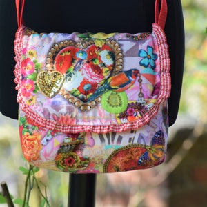 Cute shoulder bag made of colorful canvas fabric with ruffles and a golden sequin heart