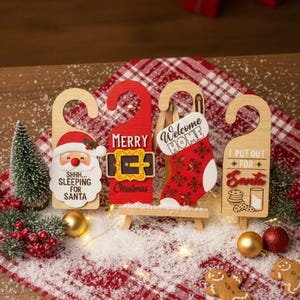 May include: Wooden Christmas door hangers with festive designs. Includes a Santa face, a red door hanger with "Merry Christmas", a stocking, and a sign with cookies and milk. Decorative holiday decor.