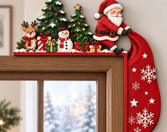 May include: A wooden Christmas door corner decoration featuring Santa Claus holding a large red sack, two green pine trees, a reindeer, a snowman, and several wrapped gift boxes. The red sack hangs down the side, decorated with white snowflakes.