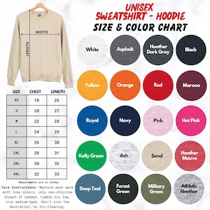 May include: A beige unisex sweatshirt displayed with a size and colour chart. The chart shows colours like white, black, and yellow. Measurements are in inches. Care instructions are also included. The sweatshirt is on a hanger.