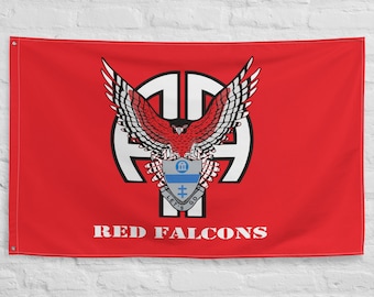 May include: A red flag with a white emblem featuring a red eagle with outstretched wings, a blue and white crest, and the text "RED FALCONS" in white. The flag is hanging on a white brick wall.