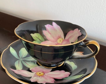 Hand painted vintage black teacup and saucer with Pink Iris made in Japan.