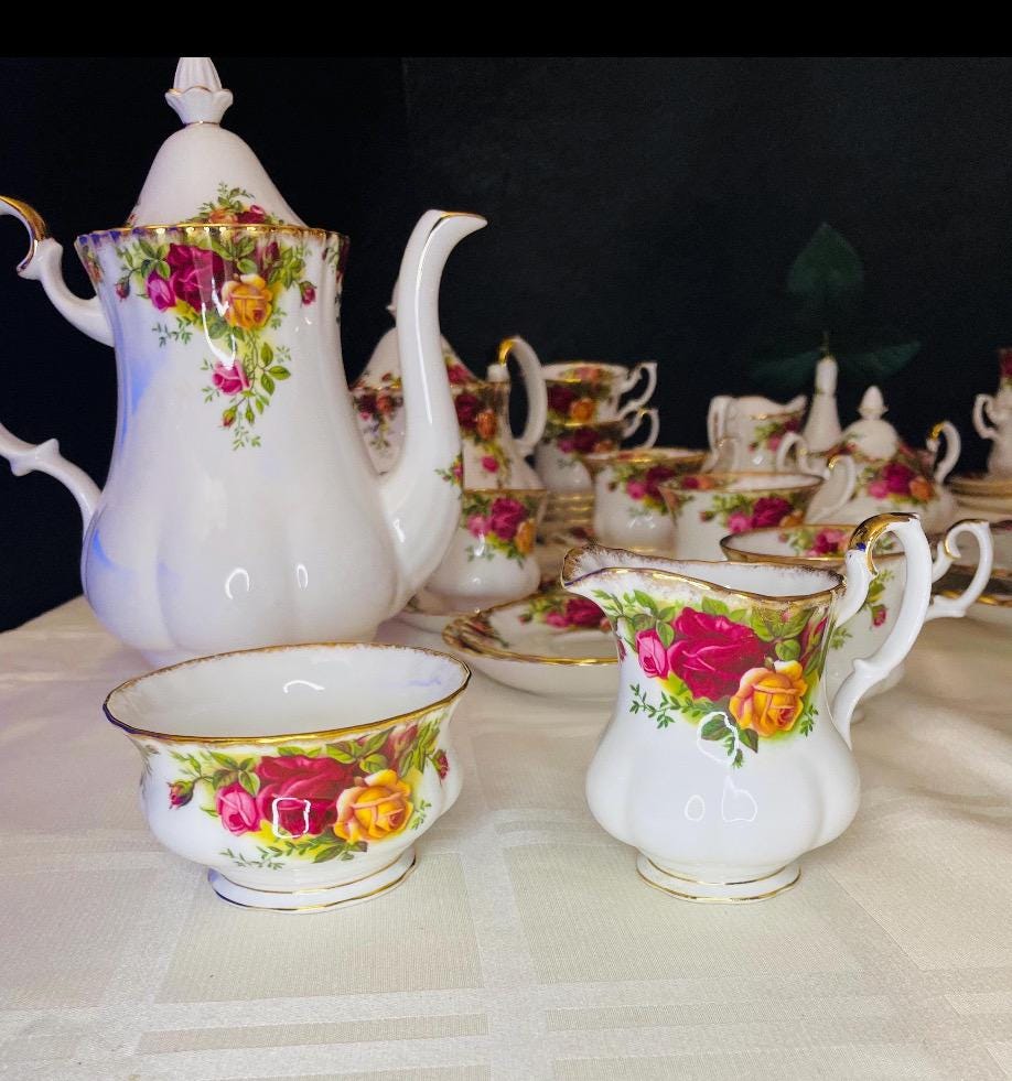 Porcelaine Coffee set Old Country Road by Royal Albert  Made in England. Serves  12 . Bone China with 22 k Gold Trim Floral Roses motif .