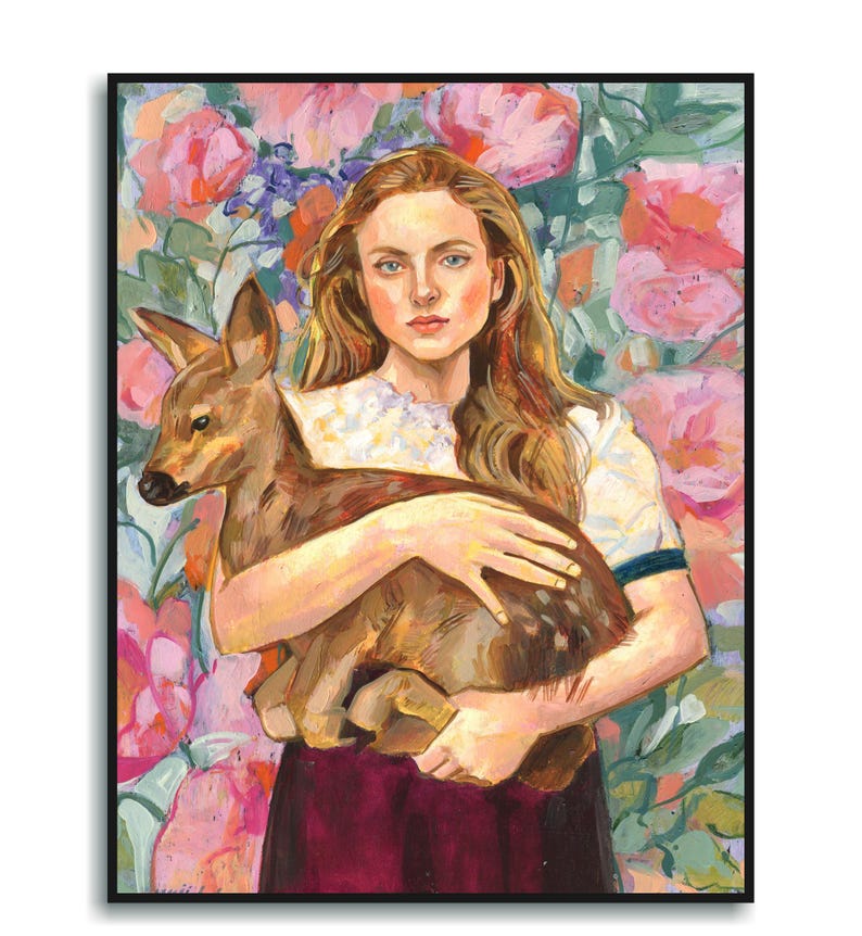 May include: A framed painting depicts a woman with long, wavy auburn hair holding a fawn. The woman wears a white blouse and a burgundy skirt. The background features a floral design with pink and purple flowers. The artwork is enclosed in a black frame.