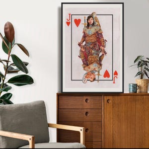 May include: Framed art print featuring a playing card design, the Jack of Hearts. The artwork depicts a person in medieval attire with an owl, set against a light background. The card's suit symbol and value are visible.