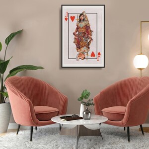 May include: A framed art print featuring a playing card design, the Jack of Hearts. The artwork depicts a person in medieval attire, with a mirrored image below. The print is displayed above two coral-colored armchairs.