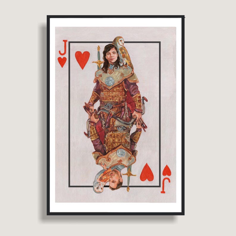 May include: A framed playing card art print featuring the Jack of Hearts. The artwork depicts a person in armor with a sword and an owl, with a mirrored image below. The card's corners display the "J" and heart symbols.