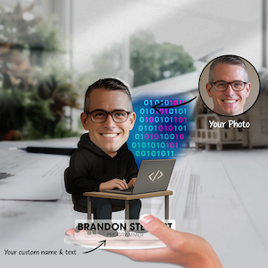 May include: A personalised programmer caricature featuring a man with glasses and a black hoodie, seated at a desk with a laptop. The image includes binary code and a photo. Text reads "BRANDON STE Programmer" and "Your custom name & text."