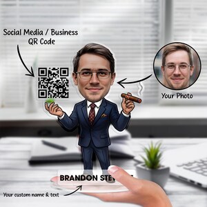 Pode incluir: Figura de acrílico personalizada de um homem de fato azul marinho, segurando um charuto. A figura tem uma cabeça de desenho animado com óculos e um código QR. A base diz "BRANDON STE" com o texto "Your custom name & text". Uma foto também está incluída.
