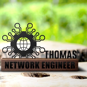 May include: A black metal desk plaque with a stylized globe and circuit board design. The plaque reads "THOMAS NETWORK ENGINEER".