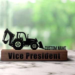 May include: Black metal silhouette of an excavator on a wooden plaque with the text "Vice President" and "CUSTOM NAME".