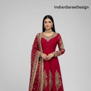 May include: A red Anarkali suit with gold embroidery. The long-sleeved dress features intricate gold patterns on the bodice and hem. A matching dupatta and pants complete the ensemble. The text "IndianSareeDesign" is visible in the image.