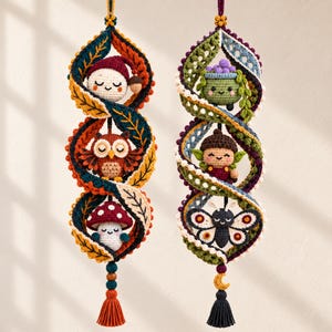 May include: Two vertical crochet wall hangings featuring spiral leaf-patterned frames. The left hanging displays a gnome, an owl, and a mushroom. The right hanging features a potted plant, an acorn character, and a butterfly, finished with tassels.