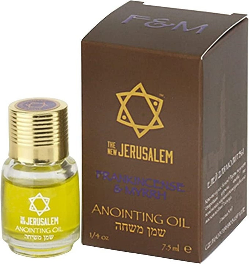 May include: A small bottle of Frankincense & Myrrh anointing oil with a gold cap and a star of David design. The bottle is labeled "The New Jerusalem Anointing Oil" and "שמן משחה". The bottle is packaged in a brown box with the same star of David design and the text "F&M The New Jerusalem Frankincense & Myrrh Anointing Oil" and "שמן משחה".