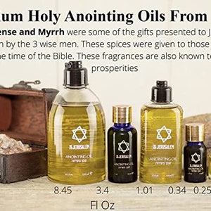 May include: Five bottles of anointing oil from Jerusalem, Israel. The bottles are clear glass with gold lids and labels. The labels feature a Star of David and the words "In Jerusalem" and "Anointing Oil". The bottles are arranged in a row from largest to smallest, with the largest bottle being 8.45 fl oz and the smallest bottle being 0.25 fl oz.