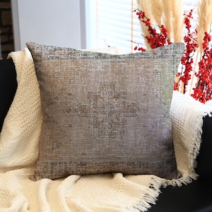 Kilim Pillow with Faded Rug Pattern on Textured Brown Fabric, Decorative Cushion for Rustic, Vintage, and Boho-Inspired Home Decor