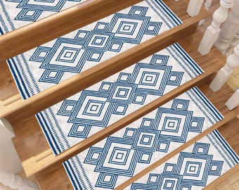 May include: Set of five blue and white patterned stair treads with a geometric design. The treads are made of a soft, durable material and are perfect for adding a touch of style to any staircase.