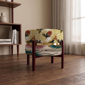 May include: A round ottoman with a dark wood frame and a gold metal band. The top section features a yellow honeycomb pattern with bees and red flowers. The bottom section displays a colorful feather print with teal, pink, and brown tones.