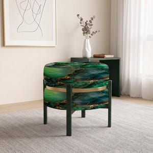 May include: A round ottoman featuring a vibrant green and teal marble-patterned fabric with gold veining details. The seat is supported by a dark frame with four straight legs and a thin gold-colored metal ring accenting the middle section.