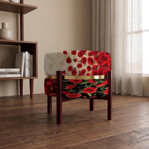 May include: A round ottoman featuring a two-tone design with a cream-colored top section and a black bottom section, both decorated with red poppy flower patterns. The piece is supported by a dark brown wooden frame with a gold-toned metal ring.