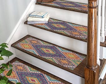 May include: A set of colorful patterned stair treads with a geometric diamond design in shades of blue, red, yellow, and green. The treads are placed on a wooden staircase with a white railing.