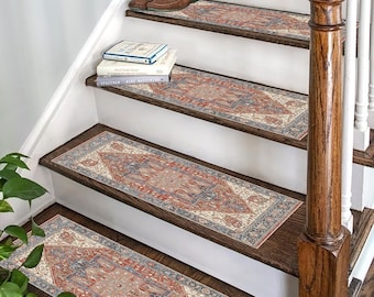 May include: A set of five stair treads with a traditional Persian-style patterned design in shades of red, blue, and cream. The treads are placed on a wooden staircase with a white railing.