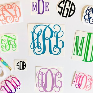 May include: Assortment of monogram decals in various colors and styles.  The decals feature different font styles and include the letters "MDE", "SEB", "FS", "HRL", "SOB", "LOC", "MOJ", and "MDE".