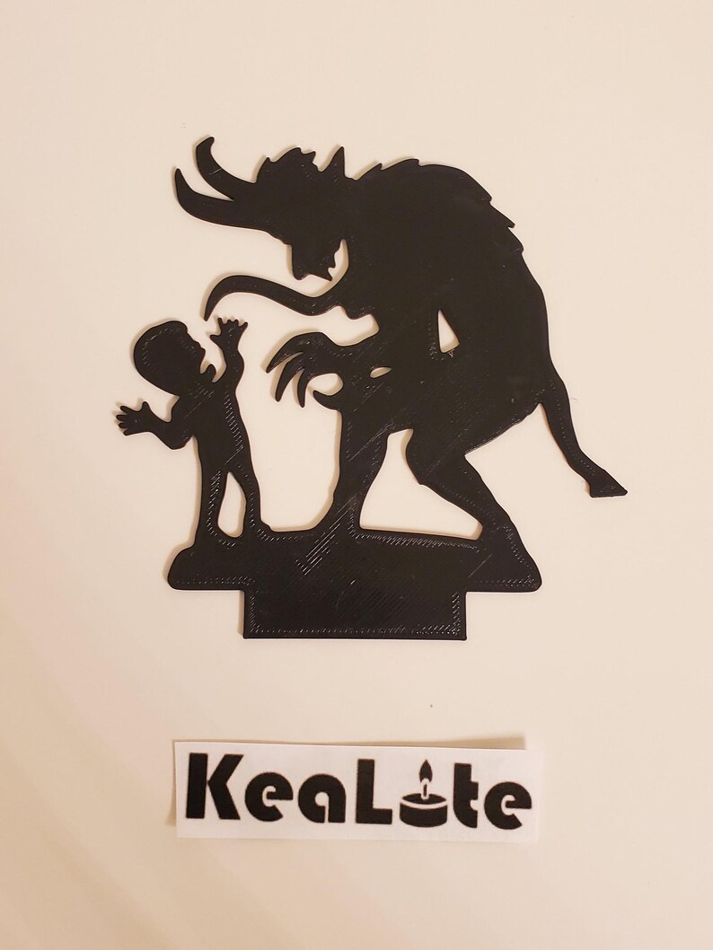 May include: Black silhouette of a devil with horns and a child standing on a base. The devil is reaching out to the child. The base is textured and has a shadow underneath.