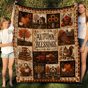 May include: A rectangular quilt featuring a patchwork design with autumn-themed illustrations including pumpkins, a red truck, a squirrel, houses, and sunflowers. The center panel displays the text Autumn Blessings in a decorative brown font.