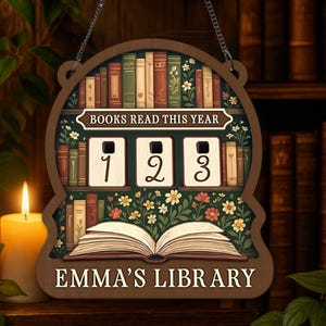 May include: Wooden sign with a bookshelf design, featuring the text "BOOKS READ THIS YEAR" and a counter showing "123". The sign also includes the text "EMMA'S LIBRARY" and is decorated with floral accents and an open book.