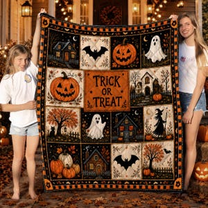 May include: A rectangular Halloween-themed quilt featuring a central panel with the text 'TRICK OR TREAT' surrounded by various quilted squares depicting pumpkins, ghosts, bats, haunted houses, trees, and a witch on a black and orange background.