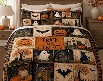 May include: A Halloween-themed quilt and matching pillow shams featuring a patchwork design of pumpkins, ghosts, bats, houses, and trees. The central panel displays the text Trick or Treat in black lettering against an orange background.