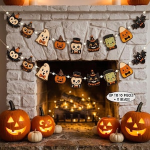 May include: A Halloween garland featuring two identical strands of cutouts including bats, owls, ghosts, pumpkins, skulls, black cats, Frankenstein monsters, and candy corn, all separated by white beads with text stating UP TO 10 PIECES + 11 BEADS.